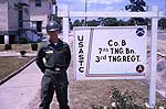 Soldier standing beside army base sign, Ft. Gordon. Soldier standing beside army base sign, Ft. Gordon.